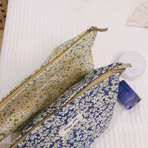 Floral cotton cosmetic bags in yellow and blue colors with simple wish label