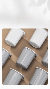 Detail view of minimalist white and grey lidded storage bins with vertical stripe texture