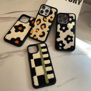Detail showing plush embroidered leopard and floral texture on iPhone protective cases
