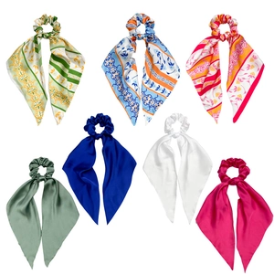 Set of seven colorful satin bow scrunchies with long ribbons in floral and solid patterns
