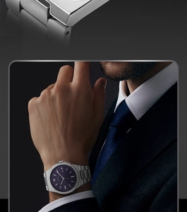 Detail of blue waffle dial and stainless steel brushed texture on a luxury men's watch