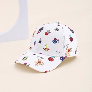 Detail of children's white baseball cap with colorful mushroom and bear cartoon prints
