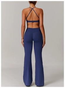 Detail of cross-back yoga bra and high-waisted flared leggings in navy blue athletic set