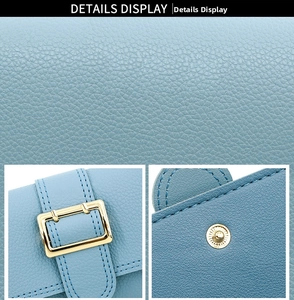 Detail of light blue litchi grain PU leather wallet with gold buckle and magnetic snap