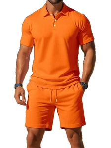 Detail of men's orange waffle knit short sleeve Polo shirt and drawstring shorts set