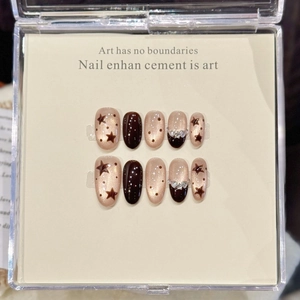 Maillard brown cat eye press-on nails with champagne stars and sparkling glitter accents