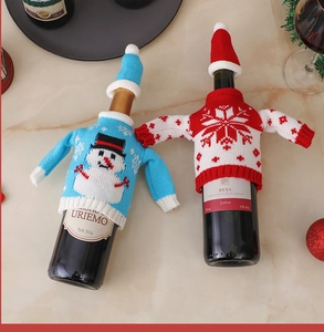 Detail of blue snowman and red snowflake knitted wine bottle covers with mini hats