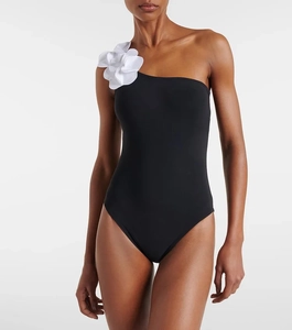 Detail of elegant black one-shoulder swimsuit with a 3D large white floral applique