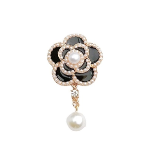 Elegant black and gold camellia flower pendant with pearl accents and dangling pearl bead