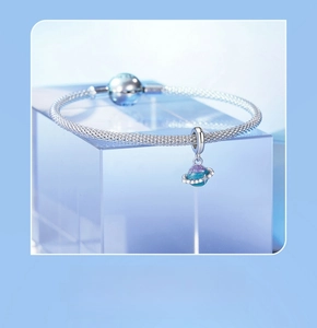 Detail of s925 silver planet charm with blue purple gradient enamel and tiny crystals