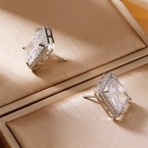 Minimalist square zircon stud earrings with radiant cut stones in silver finish
