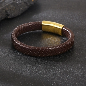 Close-up of dark brown braided leather bracelet with polished gold magnetic clasp