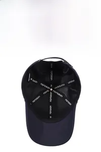Detail of the internal mesh lining and branded cotton seams of the black baseball cap