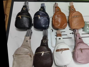 Detail showing eight colors of mini PU leather chest bags with striped webbing straps