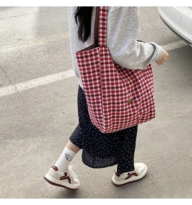 Street style view of checkered wool tote bag with casual sneakers and polka dot skirt