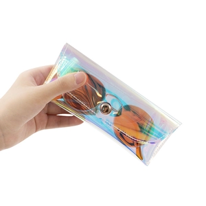 Detailed view of holographic PVC glasses pouch with metal button closure and orange sunglasses