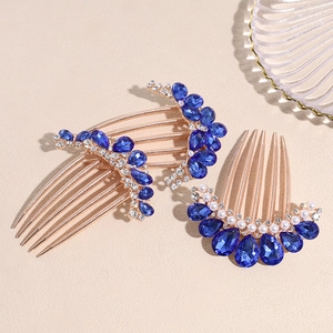 Antique style hair comb set with blue rhinestones and pearls on a gold metal base