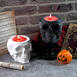 Gothic skull candle holders in black and white with red wax for Halloween decoration