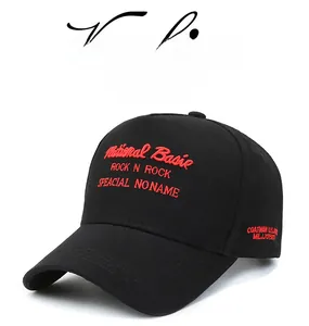 Detailed view of red National Basic embroidery on a black five-panel twill baseball cap