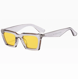 Detail view of square retro sunglasses with transparent grey frame and yellow lenses