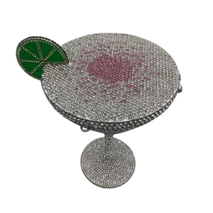 Close-up of luxury Martini glass evening bag with pink and green crystal embellishments