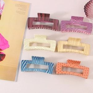 Flat lay of 10.5cm large square hair claws in leopard and geometric patterns