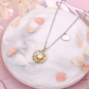 Elegant 18K gold sunflower necklace with zircon petals and a small silver heart tag