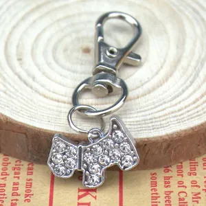 Sparkling Scottie dog pendant with rhinestones and lobster clasp on wooden stand