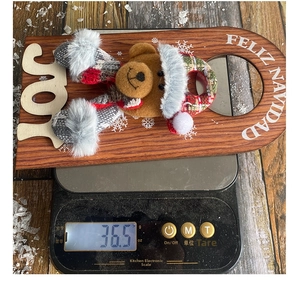 Christmas bear door hanger detail showing a light weight of 36.5g on a digital scale