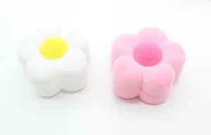 Detail view of flower shaped velvet jewelry boxes in pink and white with soft flocking