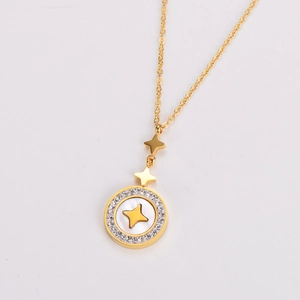 Detail of gold necklace with a diamond-set star pendant and white shell inlay