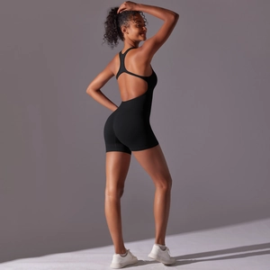 Detail of black open-back yoga bodysuit showing high-elastic fabric and racerback design