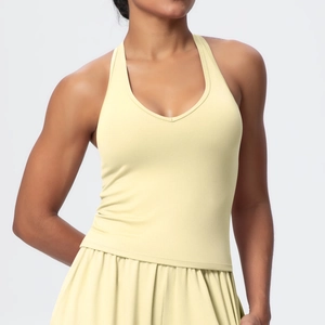 Detail of the V-neck halter sports vest and pleated tennis skirt in pale yellow