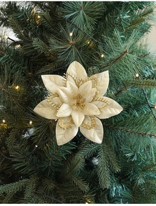 Champagne gold Christmas faux flower with glitter edges hanging on a Christmas tree