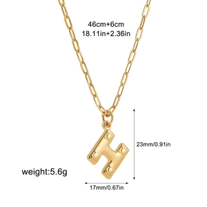Detail view of gold bubble letter H necklace with paperclip chain and size measurements