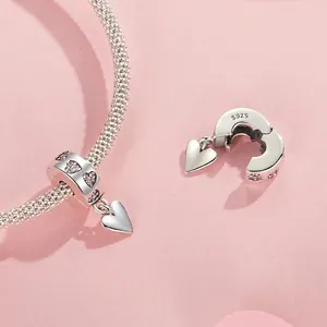 Polished S925 sterling silver heart charm with pink cubic zirconia and dangling heart