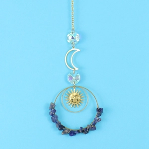 Detail of suncatcher with golden sun face, crescent moon, and blue natural stones