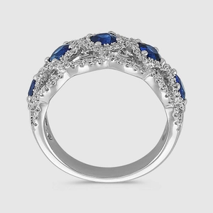 Close-up of five blue oval sapphires set in a silver wavy ring with micro diamonds
