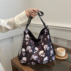 Black nylon crossbody bag with skull and floral prints and LOVE patterned strap