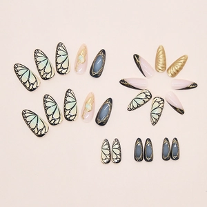 Detail of 3D French ripple press on nails with butterfly wings and gold foil texture