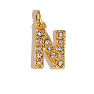 Detailed view of golden letter N pendant with sparkling zircon micro-pave setting