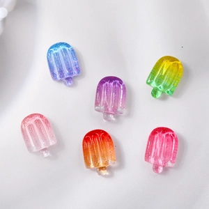 Macro shot of 3D resin ice cream nail charms with vibrant colorful gradients
