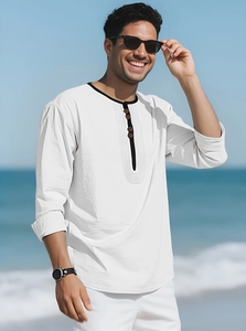 Detail of white linen beach shirt showing black trim henley collar and dark buttons