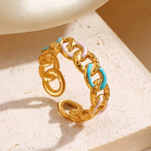Minimalist gold chain open ring with light blue and pink enamel accents on stone background