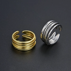 Minimalist multi-layer wrap ring set in gold and silver finish with adjustable open design