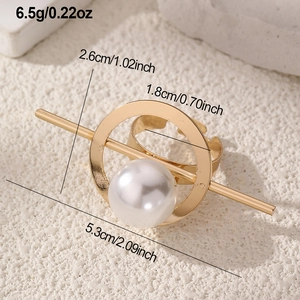 Detail view of gold open ring featuring a large white faux pearl and geometric metal frame