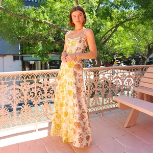 Detail of floral print patchwork on a backless maxi dress with yellow and brown flowers