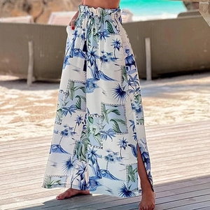 Detail of high-waisted tropical print beach pants with side slits and tassel drawstring