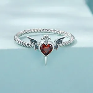 Gothic 925 sterling silver ring featuring a red heart stone with bat wings and dagger details