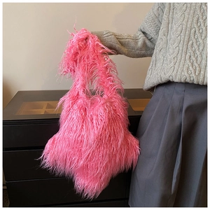 Detail of pink faux fur plush handbag showing its fluffy texture and slouchy design